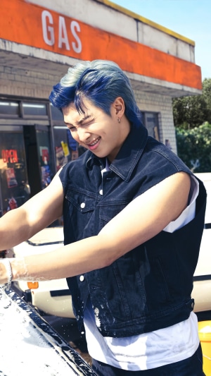 RM from BTS washing a car at a gas station