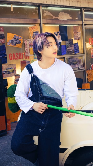 Jungkook from BTS wearing denim overalls