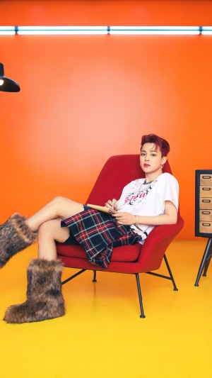 Jimin from BTS sitting in a chair