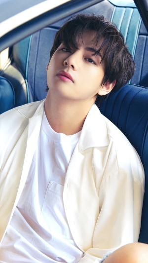 V from BTS in a white shirt and jacket