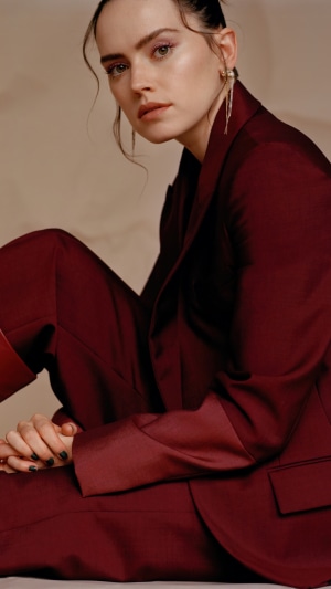 Daisy Ridley in a maroon suit
