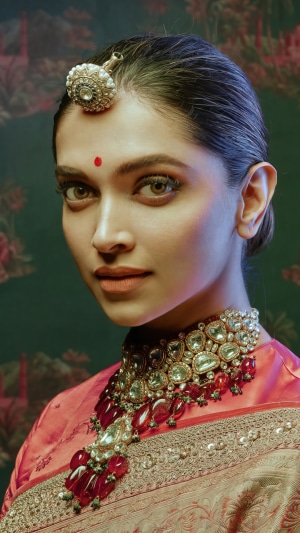Deepika Padukone wearing traditional Indian jewelry and attire