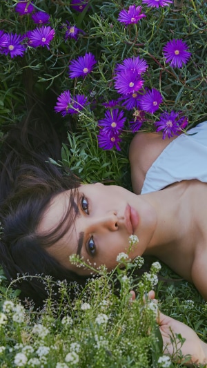 Eiza Gonzalez lying in purple and white flowers
