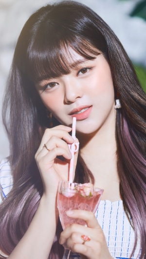 Jeongyeon from TWICE drinking a pink beverage