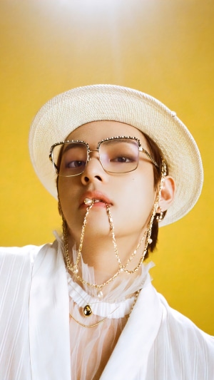 V from BTS wearing a hat and glasses