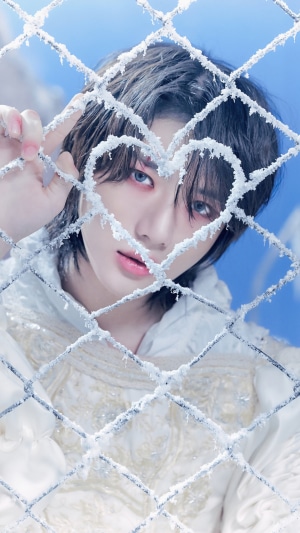 Beomgyu from TXT behind a frosted heart fence