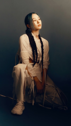 Mia from EVERGLOW posing in white outfit