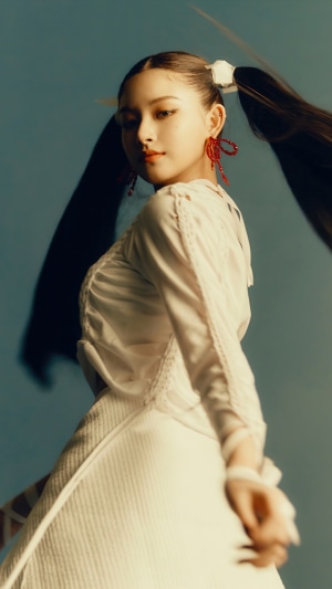 Yiren from EVERGLOW with pigtails and red earrings