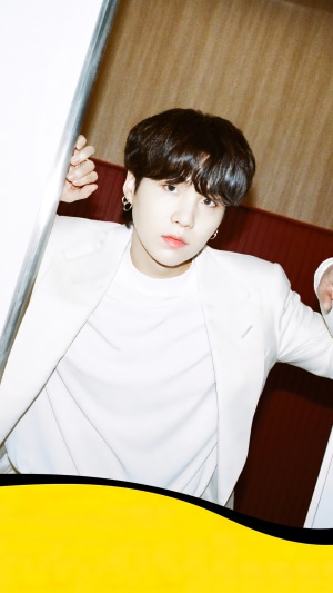 Suga from BTS wearing a white suit