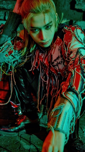 Xion from ONEUS posing in a dark setting