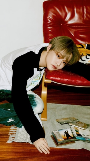 Chenle from NCT Dream lying on a chair