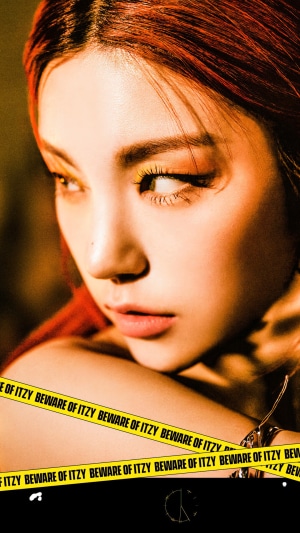 Yeji from ITZY with yellow eyeshadow and red hair