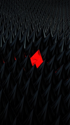 Abstract red diamond among black spikes
