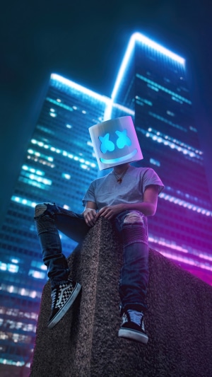 Marshmello DJ sitting in a neon city at night