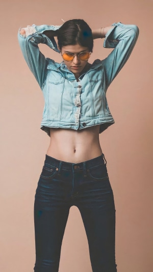 Alexandra Daddario in a denim jacket and jeans