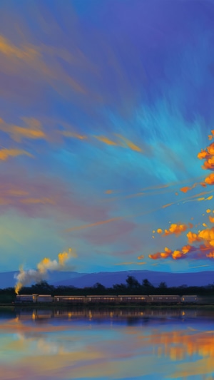 Train traveling by a lake at sunset