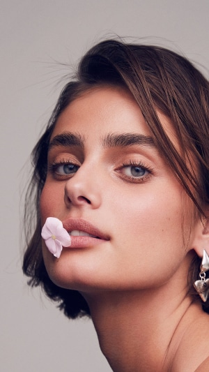 Taylor Hill with a flower on her lips