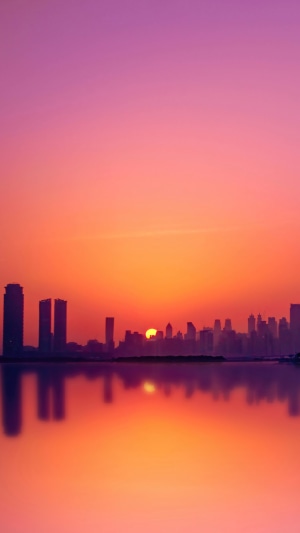 Dubai skyline at sunset reflected in water