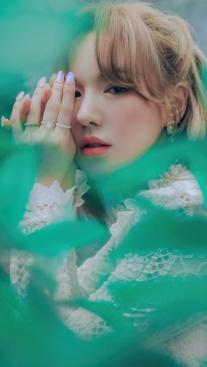 Wendy from Red Velvet among green leaves