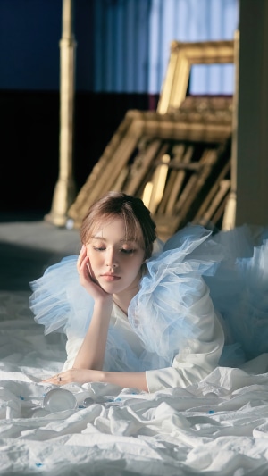 Wendy from Red Velvet lying on white fabric