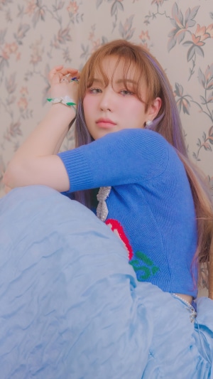 Wendy from Red Velvet posing against floral wallpaper
