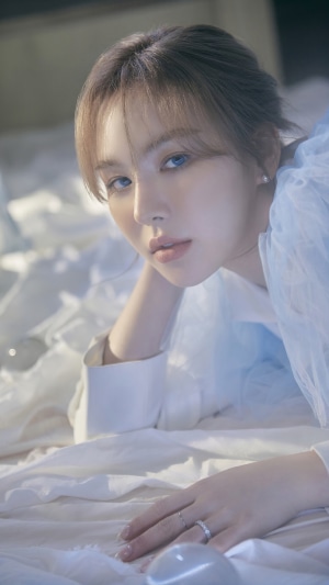 Wendy from Red Velvet lying on white fabric