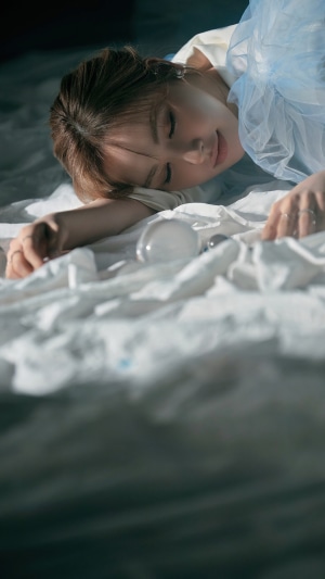 Wendy from Red Velvet sleeping on a bed