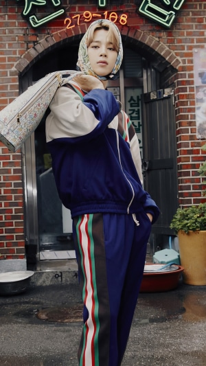 Jimin from BTS wearing a headscarf and tracksuit