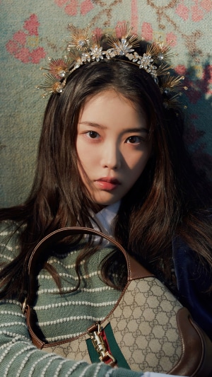 IU wearing a crown and Gucci bag