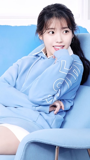 IU (Lee Ji Eun) wearing a light blue hoodie
