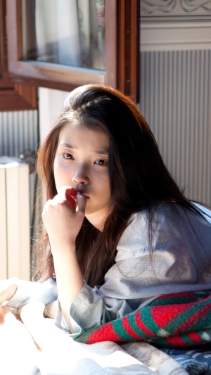 IU (Lee Ji Eun) lying down indoors