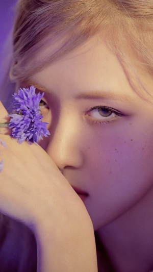 Rosé from BLACKPINK holding a purple flower