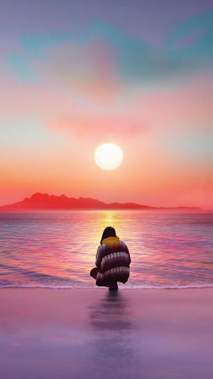 Person watching sunset over the ocean