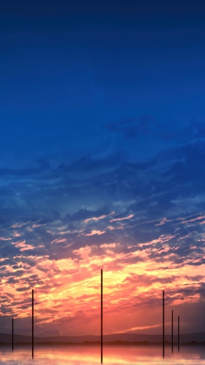 Sunset over water with poles