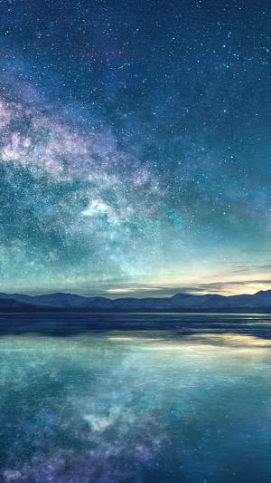 Milky Way over a calm lake and mountains