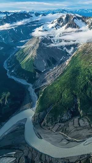 Aerial view of a glacial river flowing through mountains