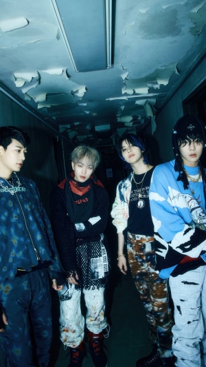 Shinee members Minho, Onew, Taemin, and Key in a dark hallway