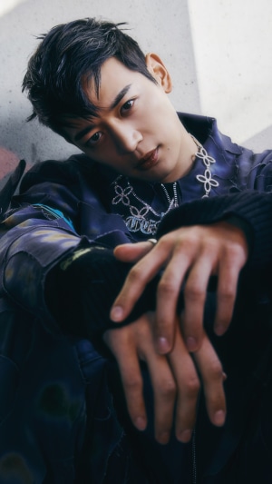 Minho from Shinee wearing a floral necklace