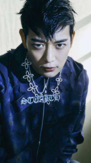 Minho from Shinee wearing a diamond necklace