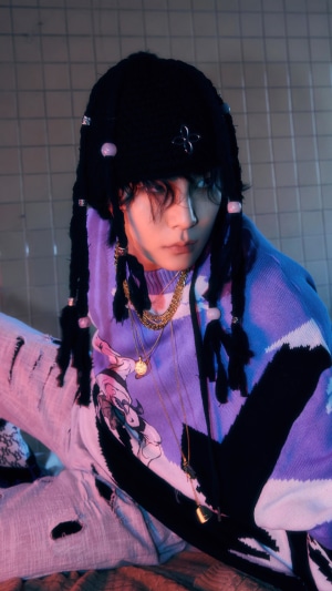 Kim Ki Bum from Shinee wearing a black beanie and purple sweater