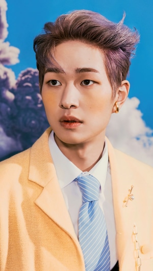 Onew from Shinee wearing a yellow suit