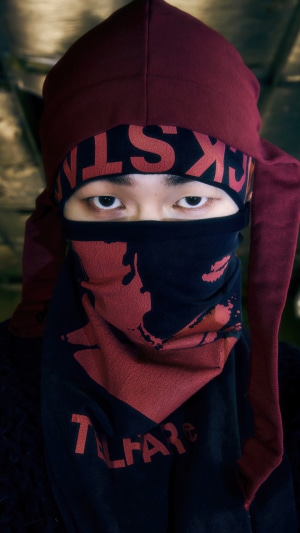 Onew from Shinee wearing a mask and hood