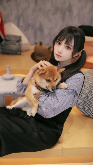 Asian girl holding a Shiba Inu dog