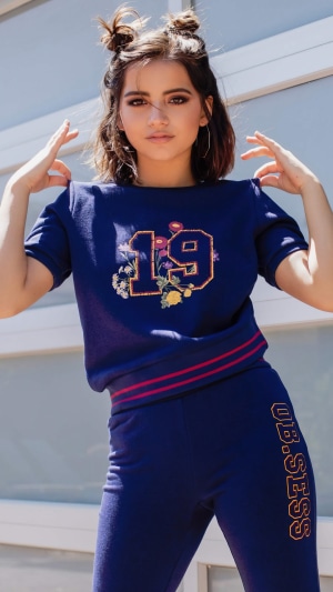 Isabela Merced in a blue tracksuit
