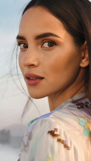 Adria Arjona looking over her shoulder