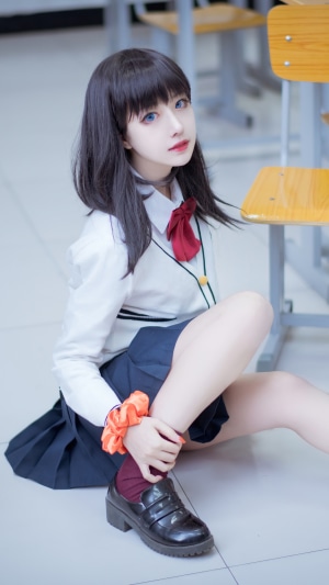 Cosplay Girl in School Uniform Sitting Indoors