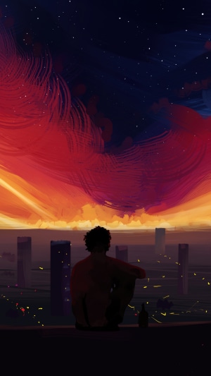 Man watching a colorful sunset over a city