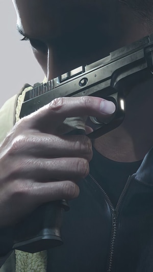 Ethan Winters holding a gun in Resident Evil Village