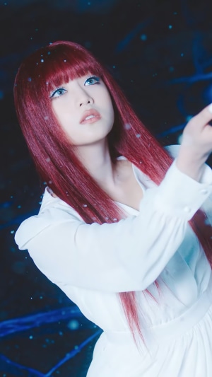 Minnie from (G)I-DLE with red hair and white dress