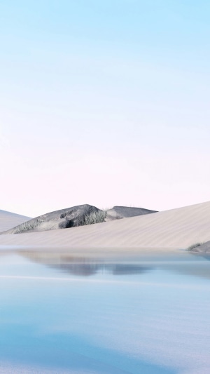 Desert landscape with sand dunes and a body of water